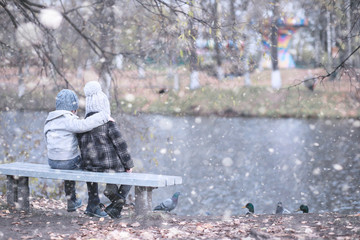 Wall Mural - Kids walk in the park first snow