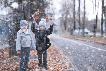 Wall Mural - Kids walk in the park first snow