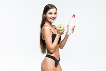 Portrait of young attractive woman with green apple and bottle wearin in black lingerie with perfect body isolated on white. Dieting concept.