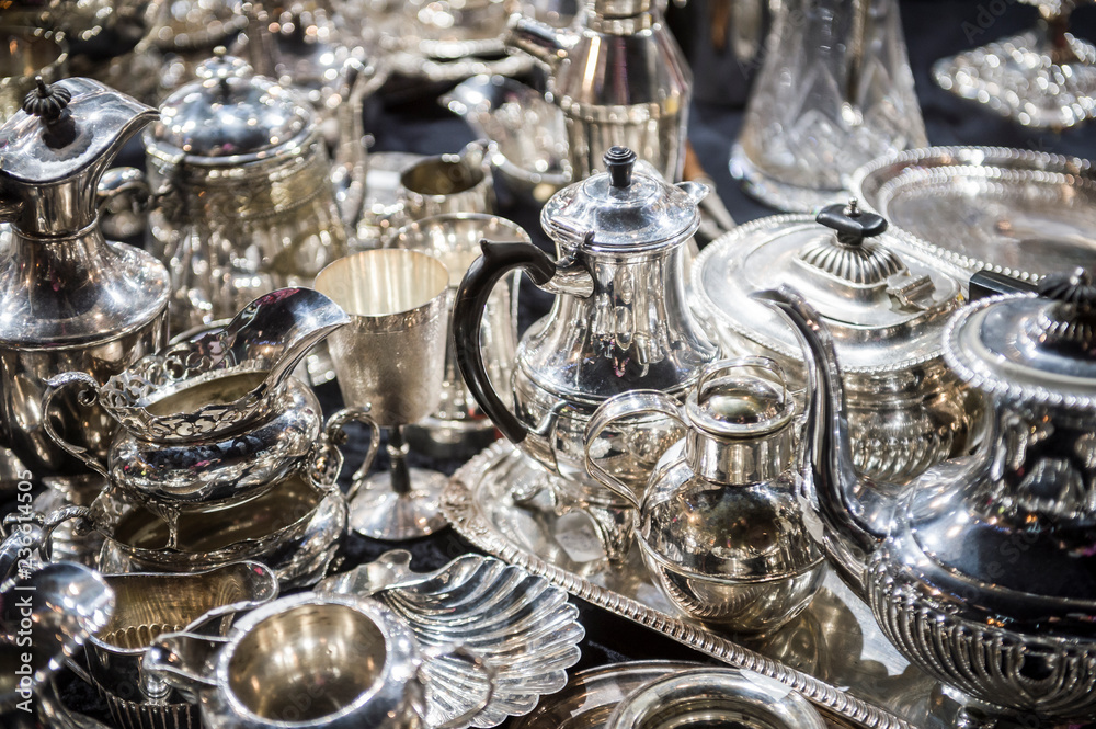 Shiny abstract background of antique silver tableware pieces in a full frame luxury jumble - obrazy, fototapety, plakaty 