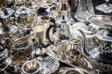 Shiny Abstract Background Of Antique Silver Tableware Pieces In A Full Frame Luxury Jumble