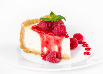 Wall Mural - Piece of cheesecake with raspberries and mint on white background.