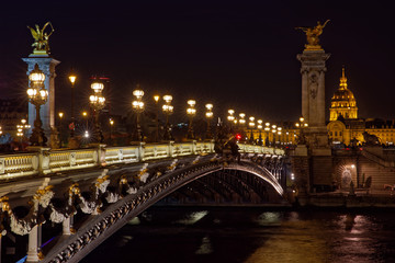  Paris, France - November 17, 2018: Alexandre 3 bridge and Invalide dome at night in Paris