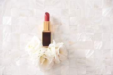 Sticker - Lipstick with beautiful flowers on white background