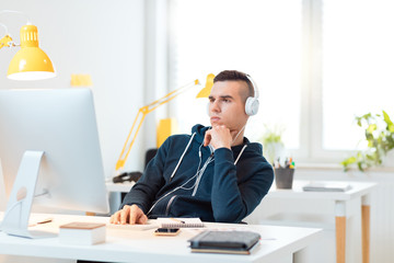 Wall Mural - Young man using computer in the office