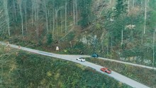 Drone footage of supercars driving up mountain pass