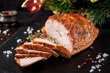 Roasted Sliced Christmas Ham Of Turkey On Dark Rustic Background. Festival Food.