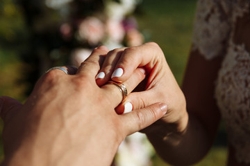 Wall Mural - wedding couple wearing gold finger rings