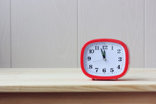 Red Alarm Clock At Twelve O'clock