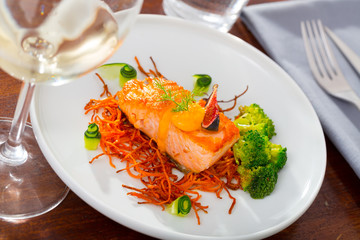 Deliciously steak of  fried salmon with smoked  carrots, broccoli and fig