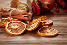 Dry Citrus Fruits, Cinnamon Sticks And Anise On Wooden Background