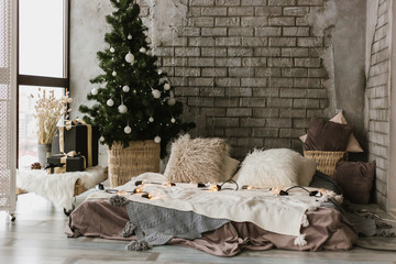 Modern living room with a bed, a Christmas tree, a window and flashlights