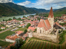 Aerial View Of Weissenkirchen Beautiful Village With Wineries In The Wachau Region Along The Danube In Austria With Medieval Fortified Roman Catholic Church