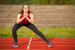 © Samo Trebizan - Beautiful young woman doing longe step on athletic track