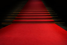 Red Carpet On The Stairs On A Dark Background. The Path To Glory, Victory And Success