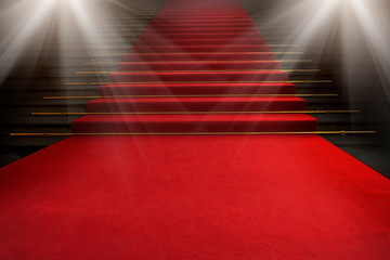 Red carpet on the stairs on a dark background. The path to glory, victory and success