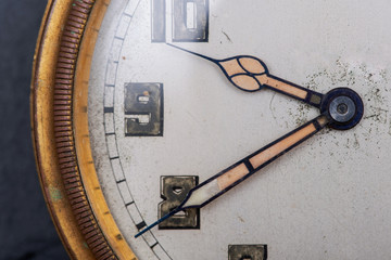 Old antique pocket watch on natural stone background.