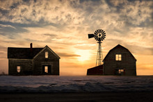 Old Abandoned Silhoetted House And Barn With Beautiful Sunset
