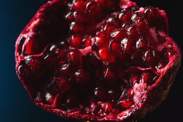 Wall Mural - Delicious, juicy, ripe pomegranate in drops and splashes of water