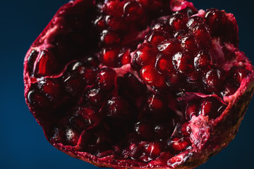 Wall Mural - Delicious, juicy, ripe pomegranate in drops and splashes of water