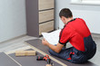 © Smole - Man Putting Together Self Assembly Furniture In New Home