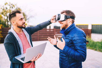 Two freelancers, developers having fun and  working on new app for virtual reality goggles