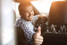 Modern Man Sitting In A Car And Showing His Thumb Up.
