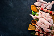 Set of chicken meat. On a black stone background. Top view. Free copy space.