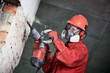 © Kadmy - worker with demolition hammer breaking interior wall