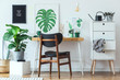 © FollowTheFlow - Stylish scandinavian open space with  office desk with mock up poster frames, a lot of plants and office accessories. Brown wooden parquet and white backgrounds wall. Floral concept of interior decor.
