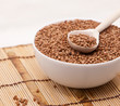 Buckwheat in a white bowl on a wooden table.
