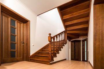 Poster - Modern brown oak wooden stairs  and doors in new renovated house interior