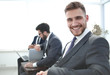 © ASDF - successful businessman sitting in an office waiting room