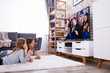 © Andrey Popov - Mother And Daughter Watching Television