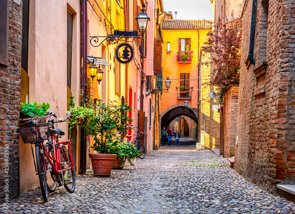 Cozy narrow street in Ferrara, Emilia-Romagna, Italy. Ferrara is capital of the Province of Ferrara - obrazy, fototapety, plakaty 