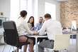 © Africa Studio - Office employees having meeting in conference room. Finance trading