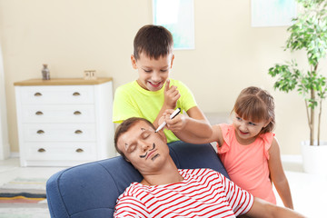 Sticker - Children painting their father's face while he sleeping on April Fool's Day