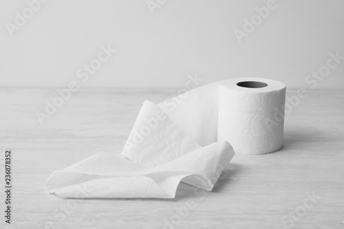 Fotomural Soft toilet paper roll on light background