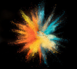 Wall Mural - Colored powder explosion on black background.