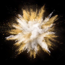 Silver And Gold Powder Explosion On Black Background.