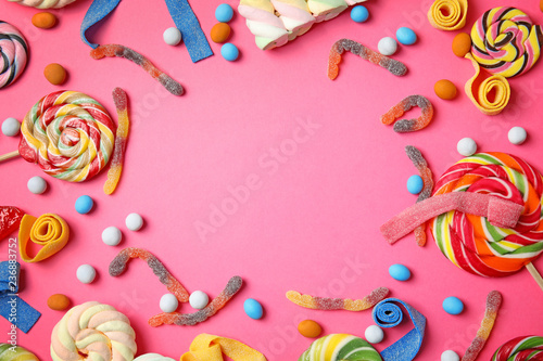 Plakat Flat lay composition with different yummy candies and space for text on color background
