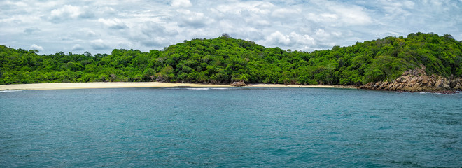  A panorama of Bahia Riscalillo beach at Huatulco National Park in Oaxaca. Travel in Mexico, Pacific Ocean.