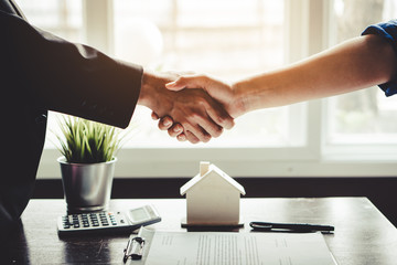 Wall Mural - The homeowner is happy after receiving the transfer of the right to occupy the home. Agent and client shaking hands after signed document and done business deal for transfer right of property.