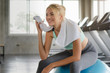 Cheerful girl smiling in gym feel fresh after exercise.