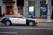 © Tricky Shark - Modern police car chases the offender at high speed with the siren and lights in the city. Policemen serve on city roads. Rush to the scene. Prevention of crime. Elite Police Unit.Charged car racing