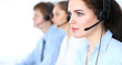 © rogerphoto - Call center operators at work. Focus at  business woman in headset