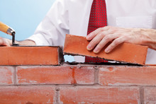 Businessman Building A Brick Wall.