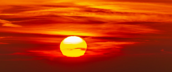 Wall Mural - panorama of the sky at sunrise with a solar disk