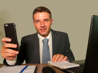 young attractive and happy businessman in suit and necktie working on office laptop computer desk isolated on white background smiling successful and confident