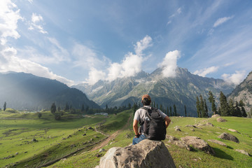 Wall Mural - traveler man with backpack relax and enjoying beautiful mountain and nature landscape view in summer